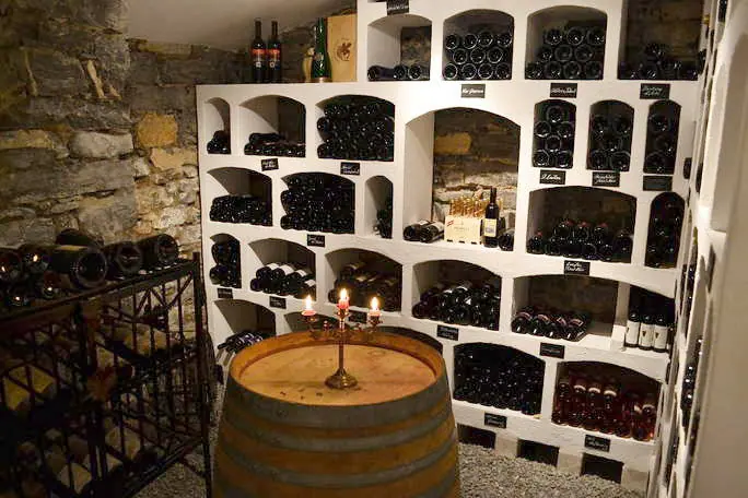 Barrel with a candlestick in front of the wine racks