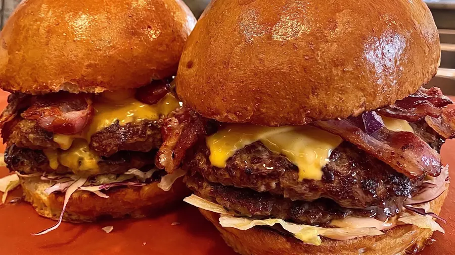 Two burgers with beef, veal and bacon