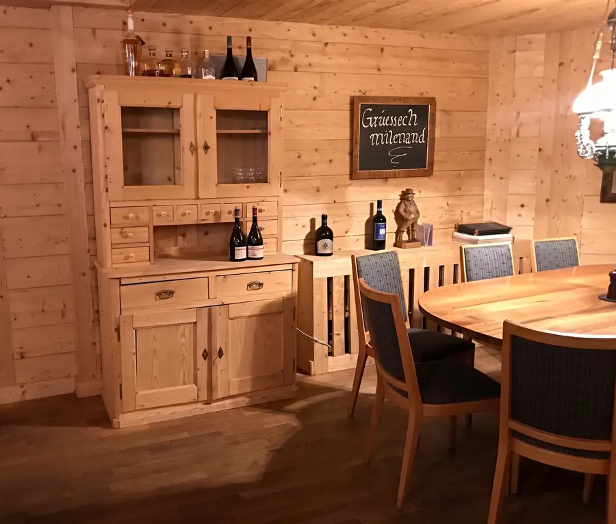 Round table in front of the old sideboard