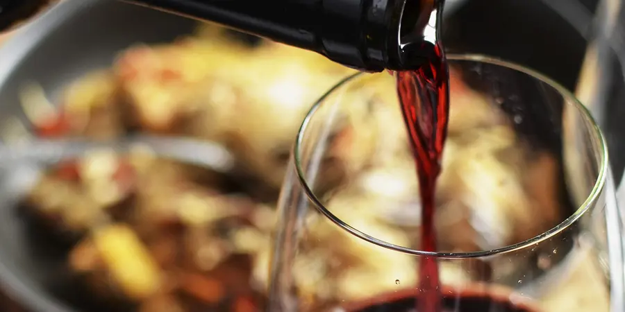Red wine being poured into a glass